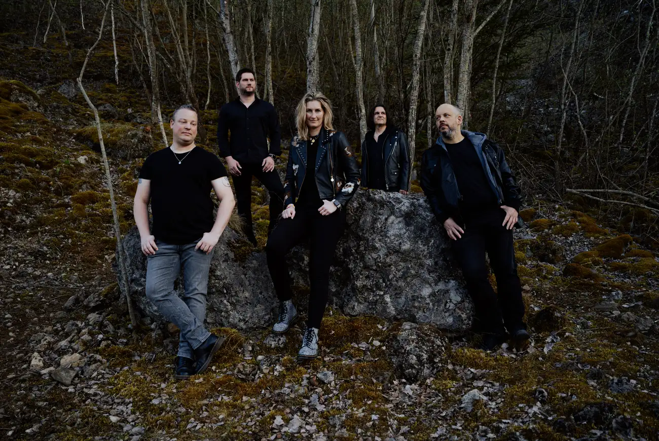 Go By Brooks standing together in a shadowed forest